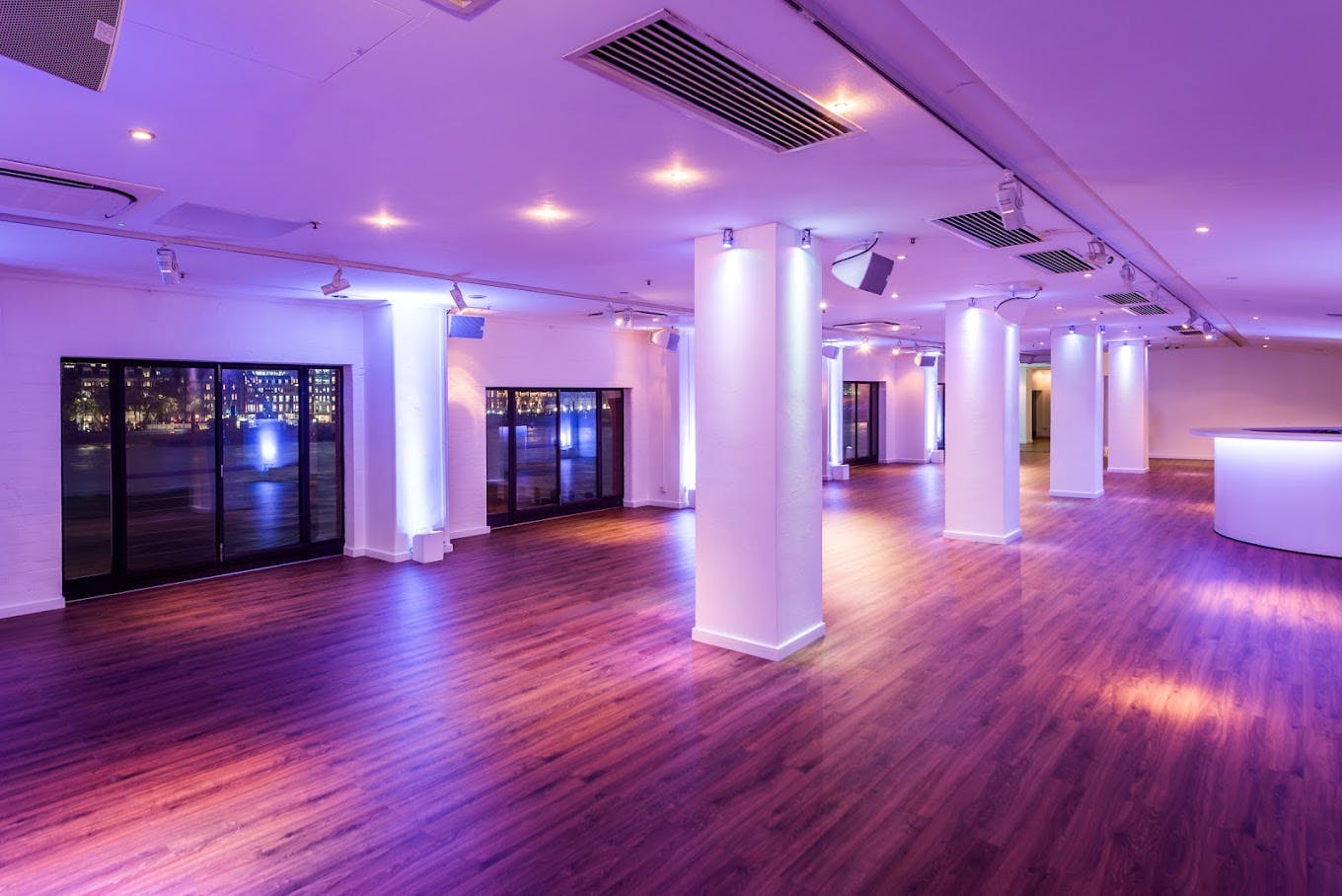 Versatile OXO2 venue with polished wooden floor, ideal for corporate meetings and social events.